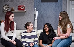 Four girls talking on a couch