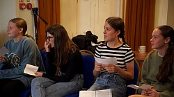 Students listening to a director